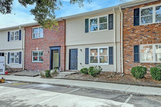 view of property featuring uncovered parking