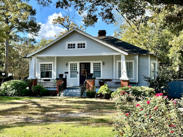 bungalow-style house featuring a front yard