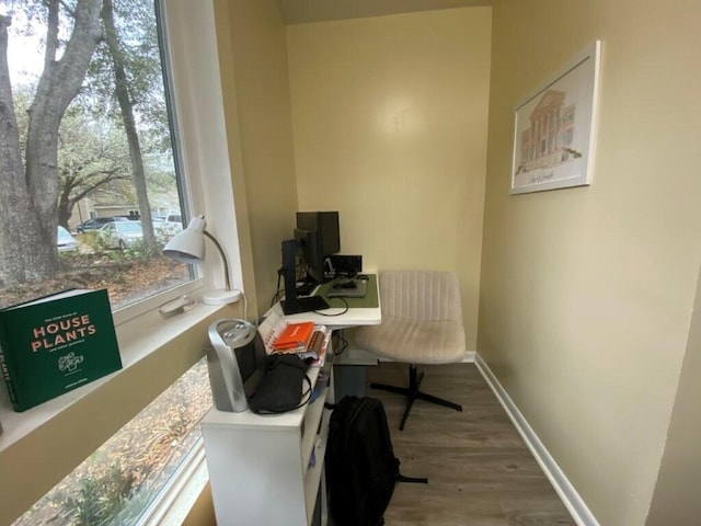 home office featuring baseboards and wood finished floors