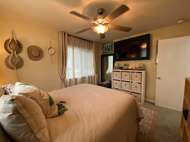 bedroom featuring ceiling fan and carpet