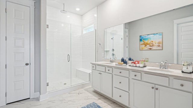 bathroom featuring marble look tile flooring, a shower stall, double vanity, and recessed lighting
