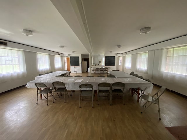 unfurnished dining area with a healthy amount of sunlight and wood-type flooring