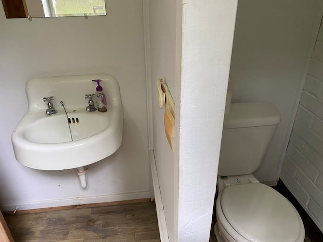 bathroom featuring hardwood / wood-style floors and toilet