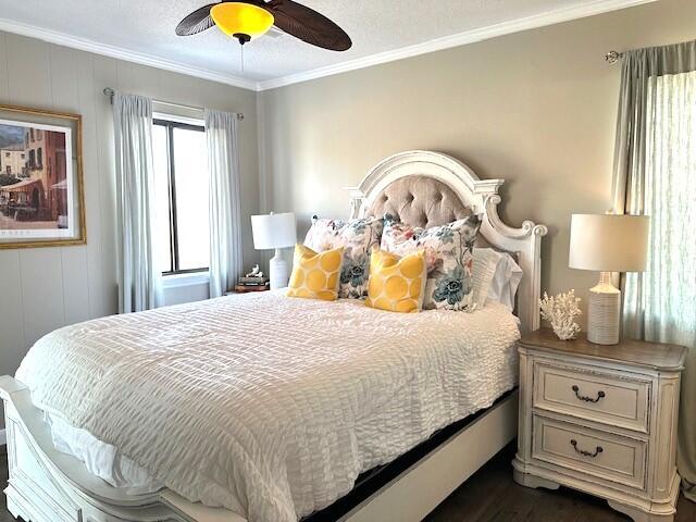 bedroom featuring a ceiling fan and crown molding