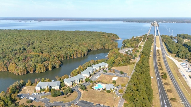 birds eye view of property with a water view and a view of trees