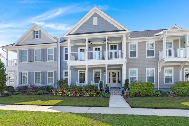 view of front of property featuring a front yard and a balcony