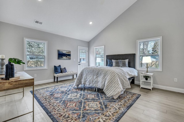 bedroom with baseboards, light wood-style floors, and visible vents