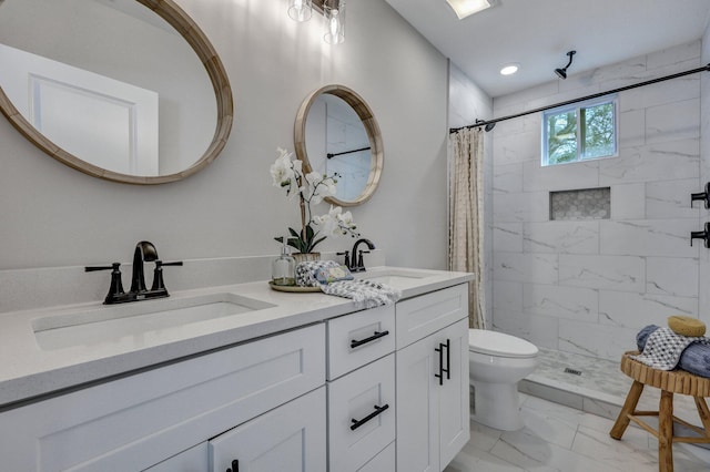 bathroom with marble finish floor, a sink, and tiled shower