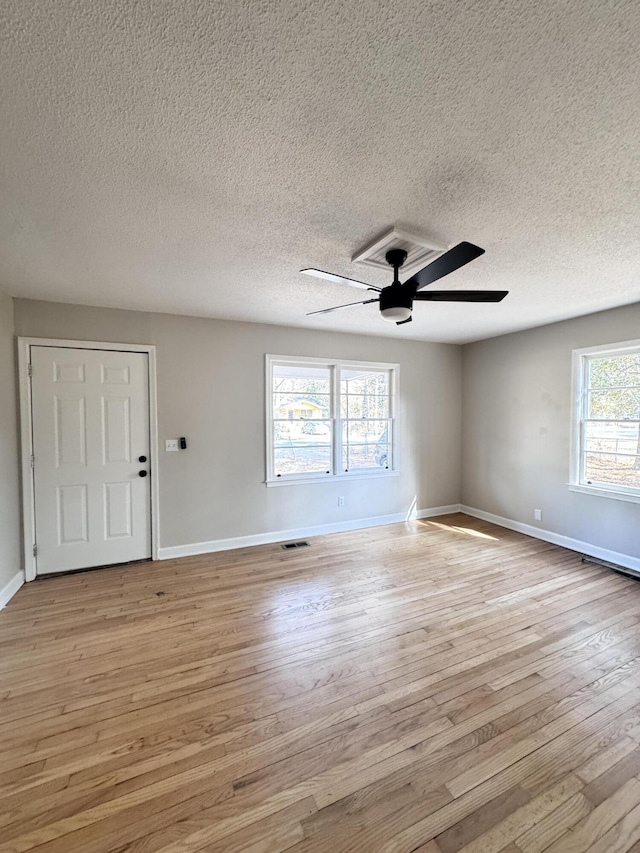114 Madison St, Walterboro, SC 29488 - empty room with light wood-style flooring, a ceiling fan, and a textured ceiling