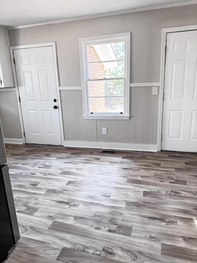 114 Madison St, Walterboro, SC 29488 - entrance foyer with wood finished floors, crown molding, wainscoting, and wooden walls