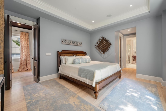 32 Prioleau St Unit J, Charleston, SC 29401 - bedroom with ornamental molding, light wood-style floors, a tray ceiling, recessed lighting, and connected bathroom