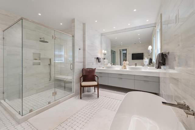 32 Prioleau St Unit J, Charleston, SC 29401 - bathroom featuring a freestanding tub, a shower stall, double vanity, recessed lighting, and tile patterned floors