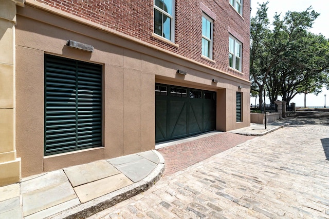 32 Prioleau St Unit J, Charleston, SC 29401 - view of property exterior with brick siding and an attached garage