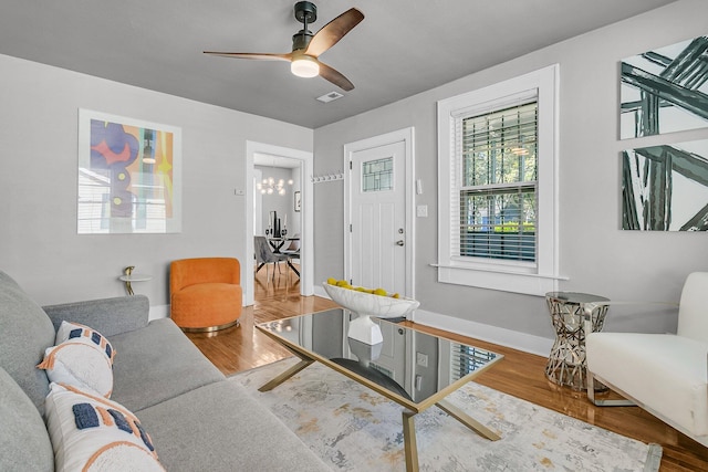 2215 Suffolk St, North Charleston, SC 29405 - living area featuring wood finished floors, a ceiling fan, and a chandelier