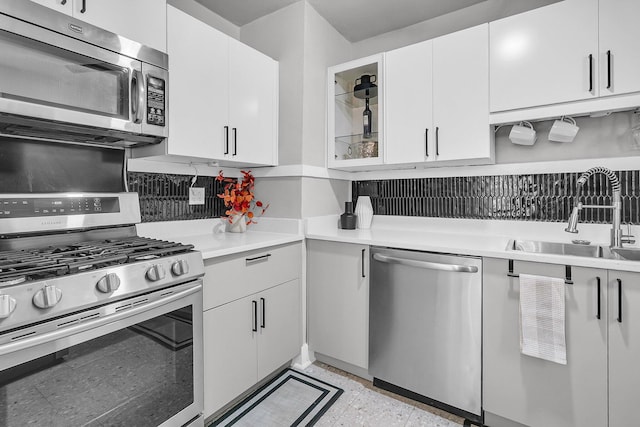 2215 Suffolk St, North Charleston, SC 29405 - kitchen with appliances with stainless steel finishes, light countertops, decorative backsplash, and white cabinetry