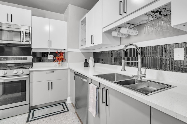2215 Suffolk St, North Charleston, SC 29405 - kitchen with appliances with stainless steel finishes, white cabinetry, and tasteful backsplash