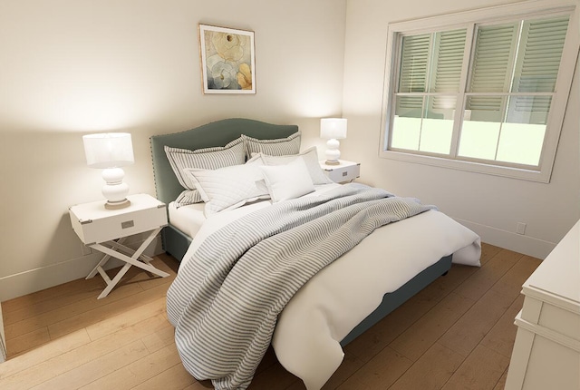 bedroom featuring light wood-style flooring and baseboards