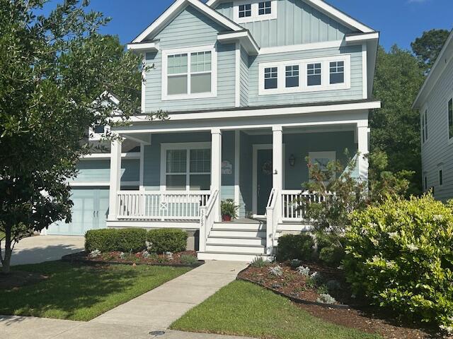 3769 Maidstone Dr, Mount Pleasant, SC 29466 - view of front facade featuring board and batten siding, covered porch, a garage, and a front yard