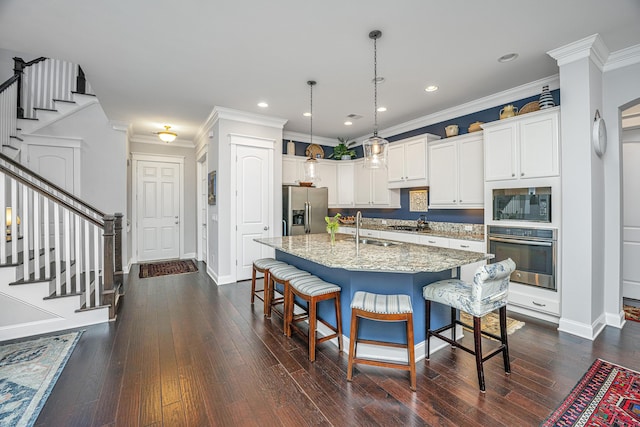 3769 Maidstone Dr, Mount Pleasant, SC 29466 - kitchen with appliances with stainless steel finishes, a breakfast bar area, light stone countertops, white cabinets, and dark wood-style flooring