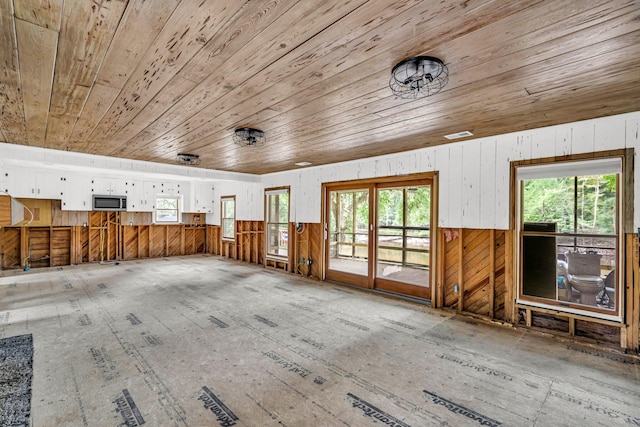 miscellaneous room featuring wood ceiling and wood walls