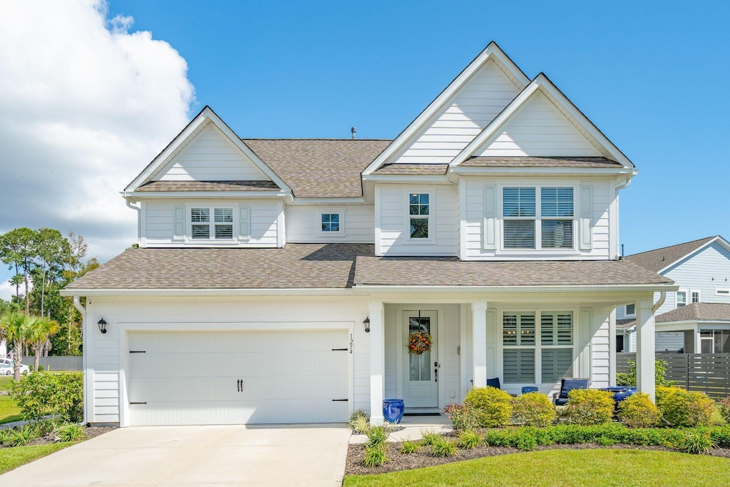 view of front of home with a porch and a garage