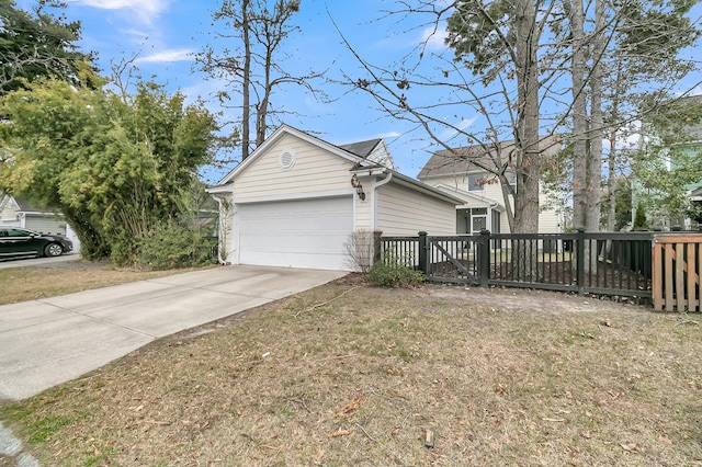 view of side of property featuring concrete driveway and an attached garage