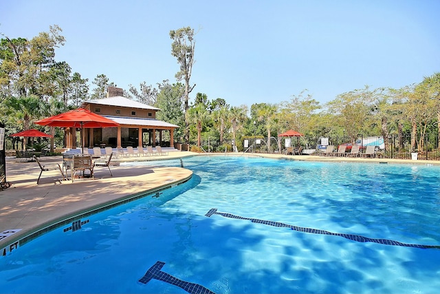 pool featuring a patio and fence