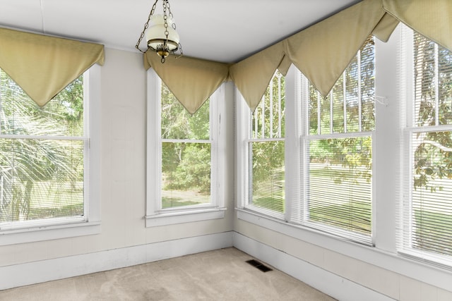 unfurnished sunroom with carpet floors