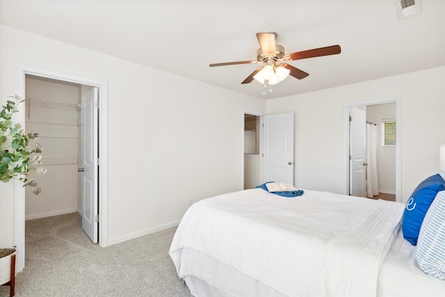9747 Seed St, Ladson, SC 29456 - bedroom with a walk in closet, light carpet, baseboards, and a ceiling fan