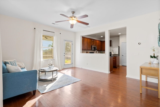 9747 Seed St, Ladson, SC 29456 - living room with wood finished floors, a ceiling fan, and baseboards