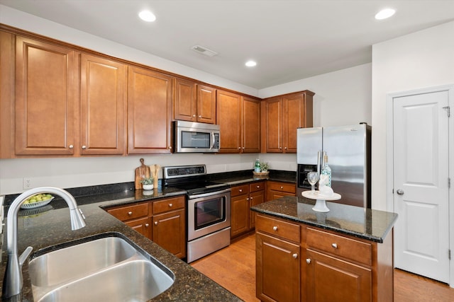 9747 Seed St, Ladson, SC 29456 - kitchen featuring stainless steel appliances, a sink, light wood-style floors, brown cabinetry, and recessed lighting
