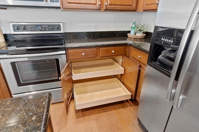 9747 Seed St, Ladson, SC 29456 - kitchen with stainless steel appliances, wood finished floors, brown cabinets, and dark stone counters