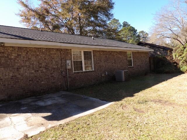 view of property exterior featuring cooling unit and a patio area