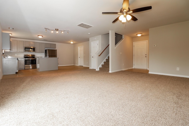 8285 Little Sydneys Way N, Charleston, SC 29406 - unfurnished living room with stairway, ceiling fan, and light carpet