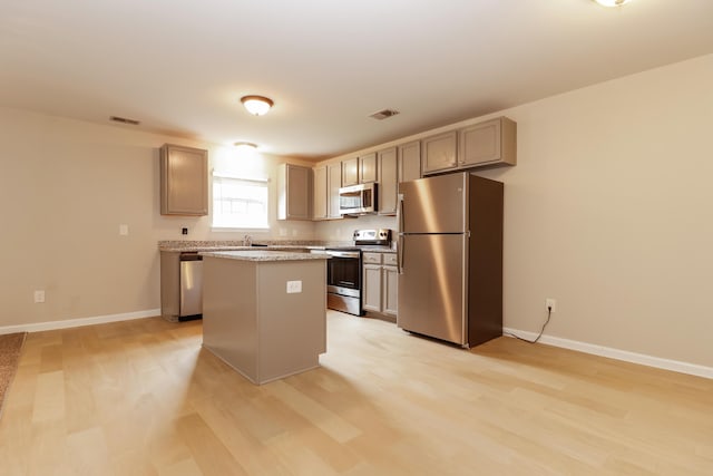 8285 Little Sydneys Way N, Charleston, SC 29406 - kitchen featuring appliances with stainless steel finishes, a center island, light wood-type flooring, and light countertops