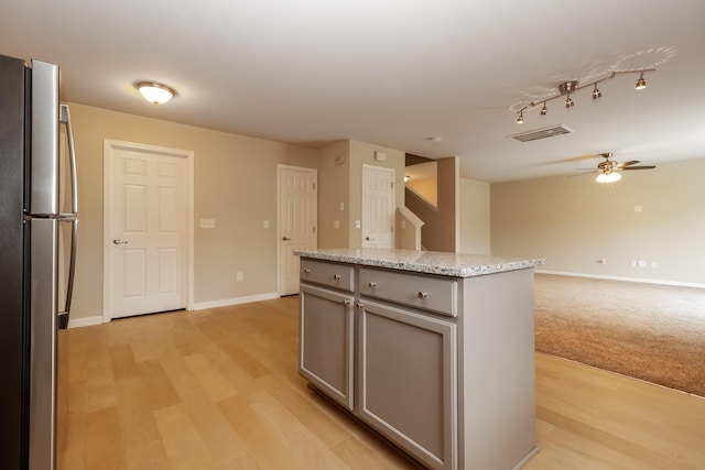 8285 Little Sydneys Way N, Charleston, SC 29406 - kitchen featuring freestanding refrigerator, gray cabinetry, light wood finished floors, a ceiling fan, and a center island
