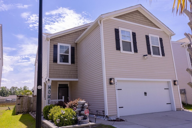 view of front of property with an attached garage and concrete driveway