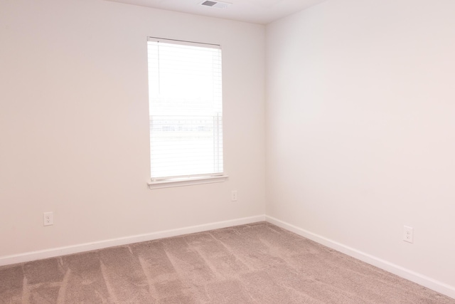 empty room featuring baseboards and carpet floors