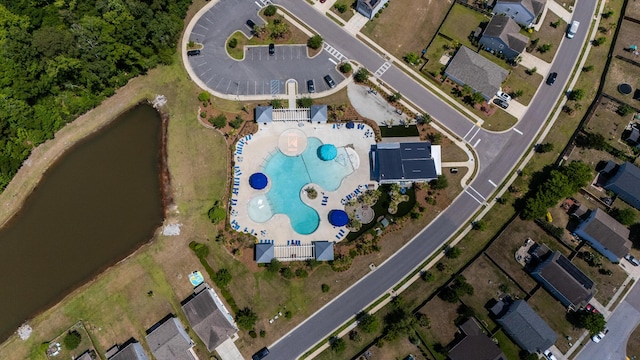 aerial view of property's location featuring a pool and a large body of water
