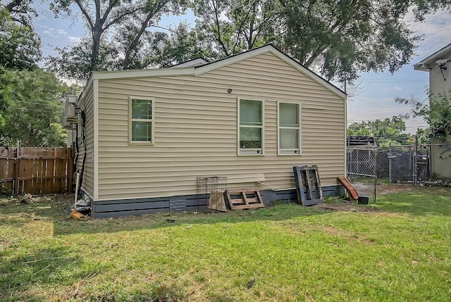 rear view of house with a yard