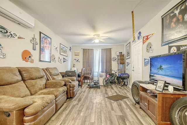 living room featuring a wall mounted AC, ceiling fan, and light wood-type flooring