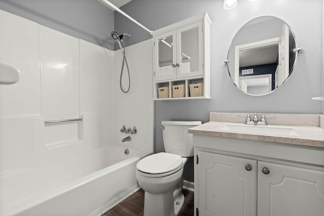 full bath featuring vanity, shower / tub combination, toilet, and wood finished floors