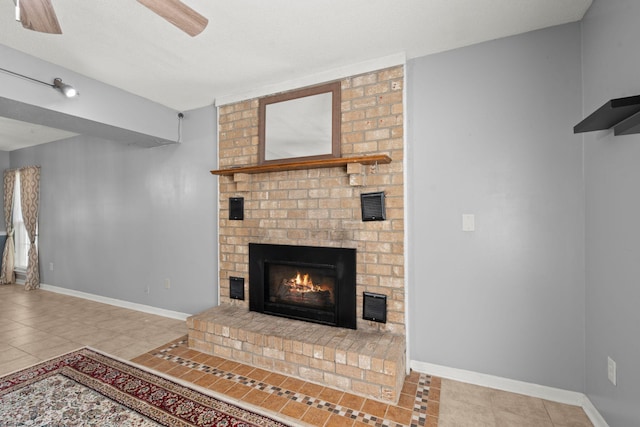 unfurnished living room with visible vents, baseboards, a ceiling fan, a fireplace, and tile patterned flooring