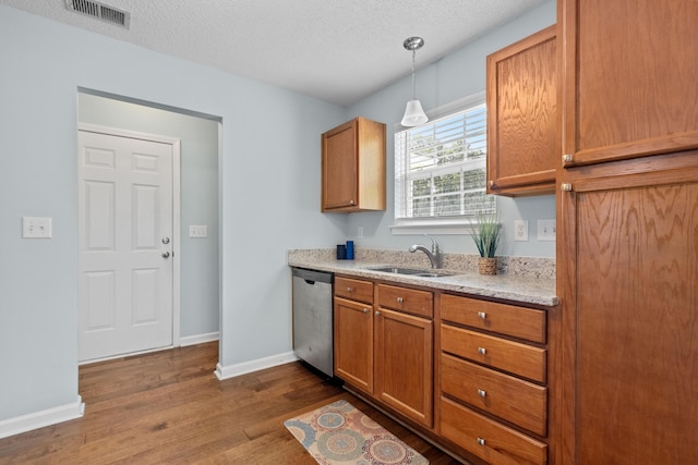 340 Stefan Dr, Charleston, SC 29412 - kitchen featuring stainless steel dishwasher, dark wood finished floors, brown cabinets, a textured ceiling, and decorative light fixtures
