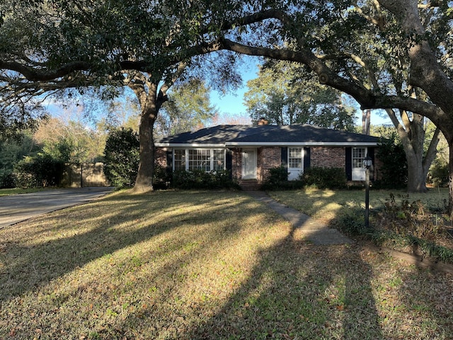 ranch-style home with a front lawn