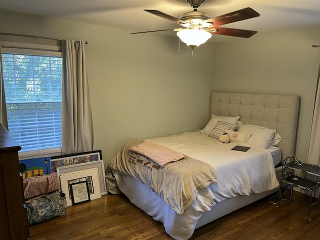 bedroom with ceiling fan and dark hardwood / wood-style flooring