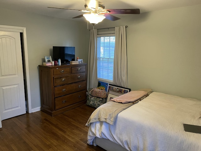 bedroom with ceiling fan and dark hardwood / wood-style flooring