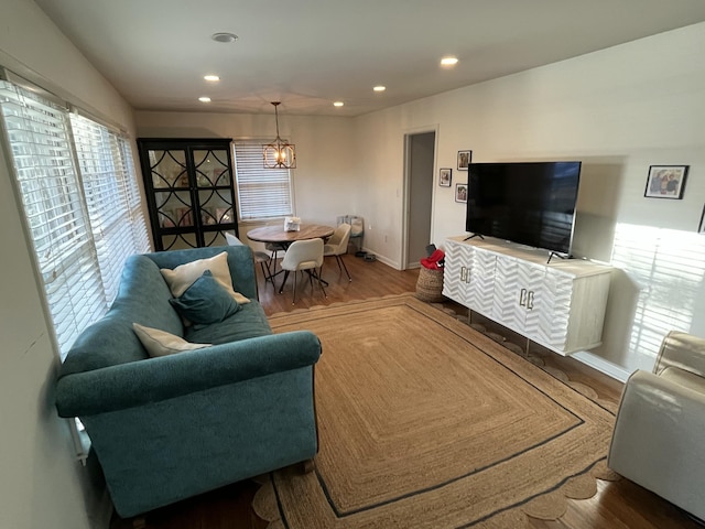 living room featuring a notable chandelier and hardwood / wood-style flooring