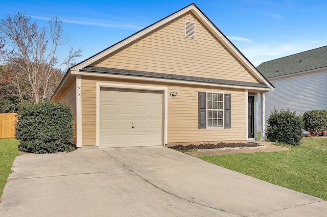 garage featuring concrete driveway and fence