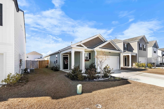 view of front of house with central AC and a garage